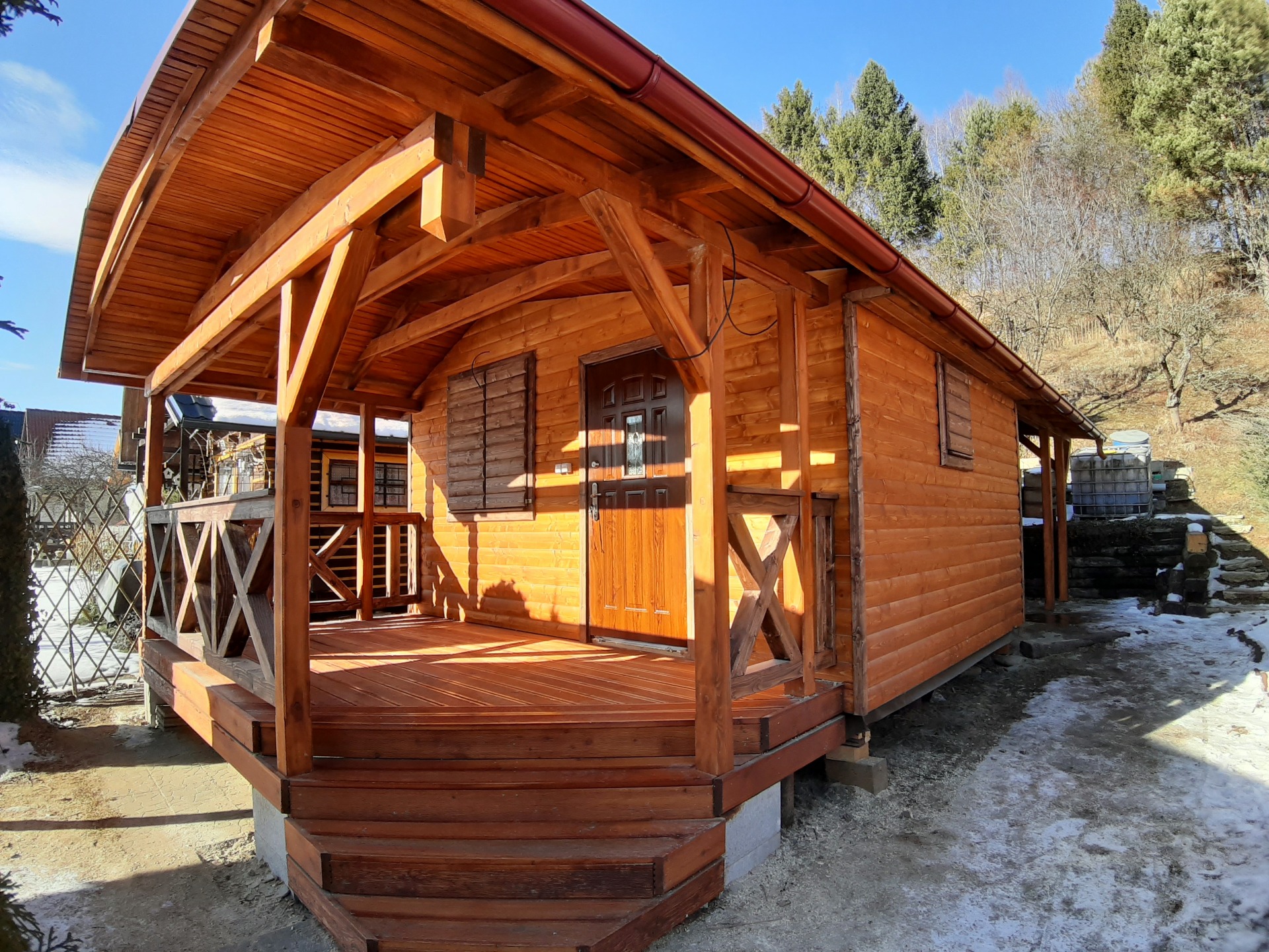 Chatka so zrubovým profilom vo farbe dub a drevebé zábradlie vo farbe palisander